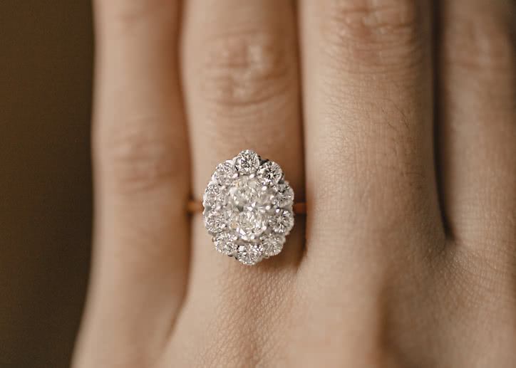 Halo engagement ring with lab-grown diamonds shaped like a flower in white gold
